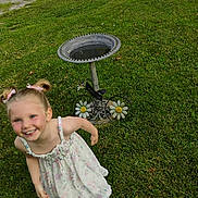 Hermonie joined the competition — help win amazing prizes! child, smiling, girl, pigtails, dress, flower_pattern, grass, birdbath, decorative, outdoor, daylight, greenery, happy, playful, nature, summer, welcome_sign, pathway, metal, garden