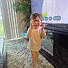 Elijah joined the competition — help win amazing prizes! child, toddler, glasses, white_tshirt, barefoot, carpet, living_room, television, plant, smiling, happy, indoor, home, furniture, curtains, person, floor, decor, technology, candid