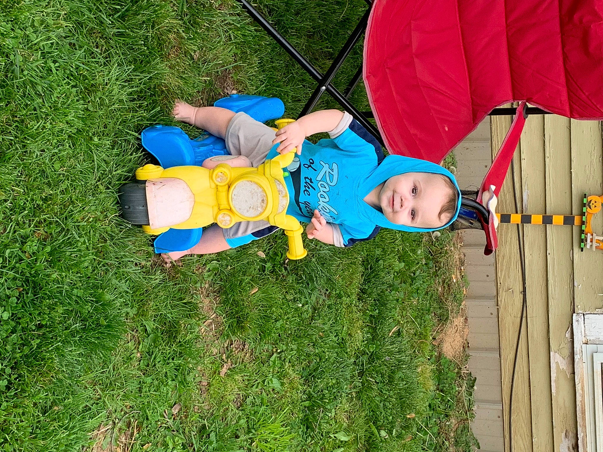 Noah Porter is registered to the contest to win money with this photo: baby_toddler_clothing, child, fashion_accessory, fun, grass, grassland, happy, hat, joy, lawn, leisure, outdoor_play_equipment, people_in_nature, person, plant, play, recreation, shorts, t_shirt, toddler