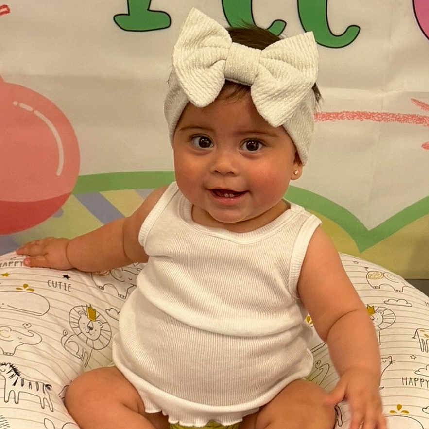 Mckenzie Rocha joined the competition — help win amazing prizes! baby, baseballcap, bodypart, bonnet, cap, clothing, cushion, face, finger, hand, hat, head, homedecor, person, photography, portrait, shorts, sitting, t_shirt, text