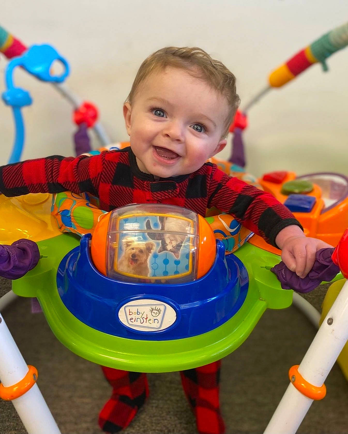 Kamden is registered to the contest to win money with this photo: arm, baby, baby_playing_with_toys, baby_toddler_clothing, blue, child, clothing, design, electric_blue, fun, happy, joy, person, play, playground, recreation, sleeve, smile, standing, t_shirt