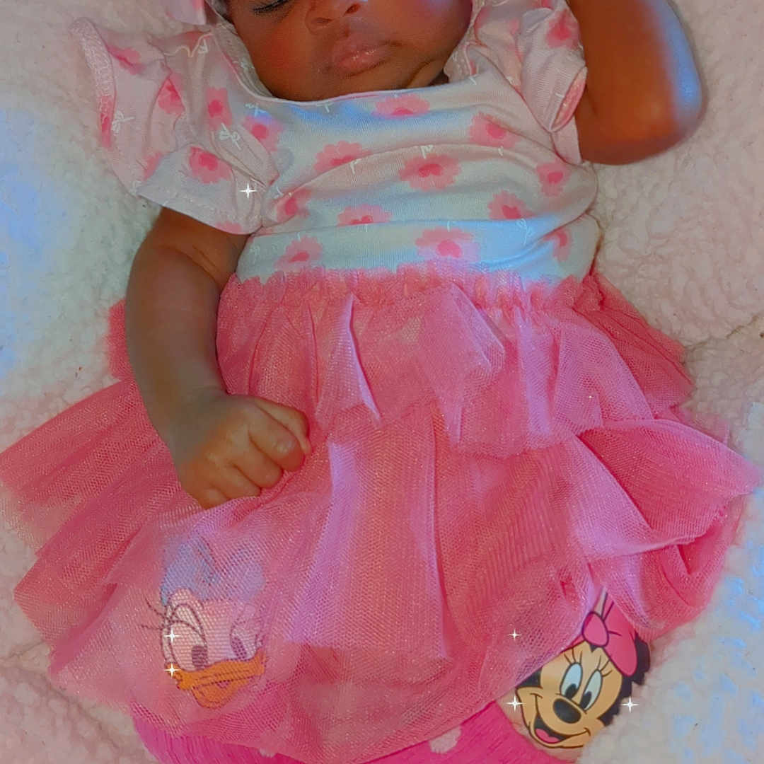 Rah'Ya is registered to the contest to win money with this photo: baby, bed, blanket, bodypart, bonnet, cap, clothing, couch, dress, face, finger, furniture, hand, hat, head, newborn, person, photography, portrait, toy