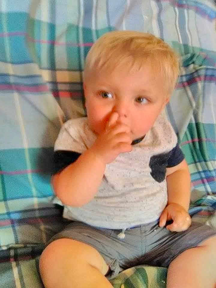 Alyjah joined the competition — help win amazing prizes! toddler, child, blonde_hair, sitting, plaid_blanket, casual_clothing, shorts, tshirt, indoor, cute, baby, face, hand, nose, young_child, person, portrait, skin, legs, furniture