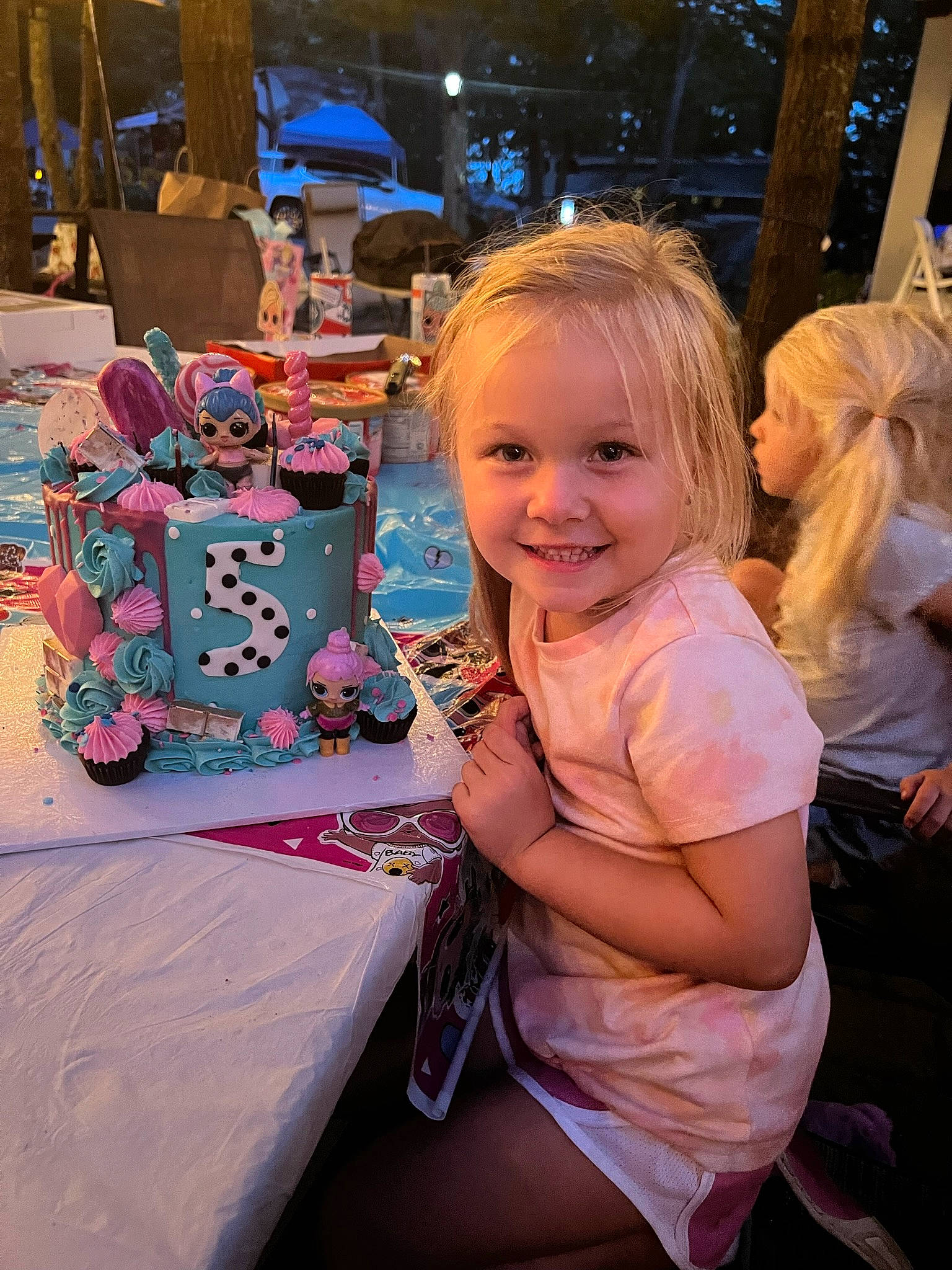 Remi is registered to the contest to win money with this photo: chair, child, event, facial_expression, fun, happy, holiday, joy, lap, leisure, magenta, party, person, pink, plant, purple, recreation, sitting, smile, toddler