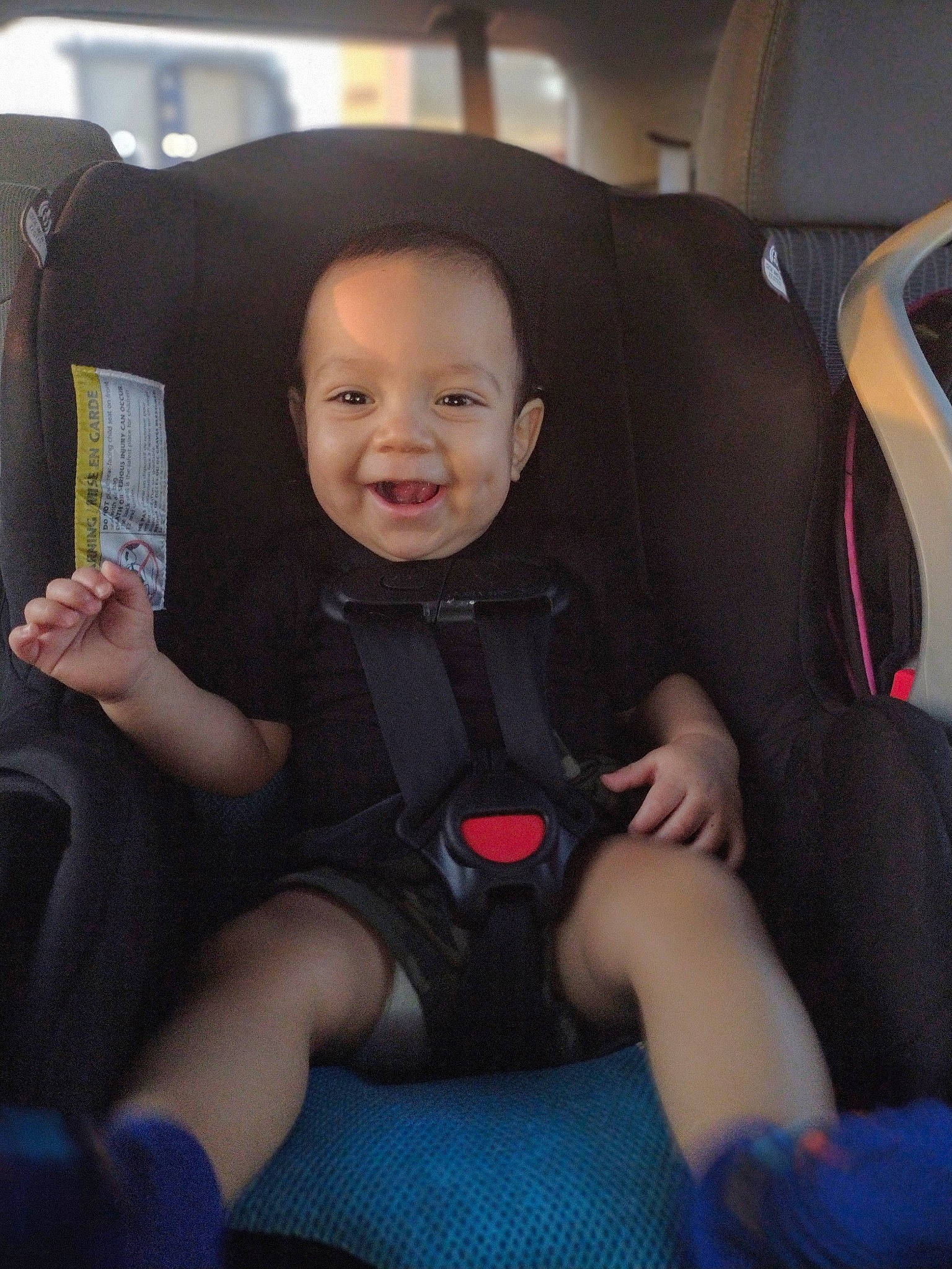 Emmitt is registered to the contest to win money with this photo: auto_part, automotive_design, baby, baby_in_car_seat, car_seat, car_seat_cover, comfort, family_car, finger, fun, head_restraint, human_leg, joy, lap, luxury_vehicle, motor_vehicle, person, seat_belt, smile, steering_wheel