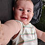 baby, child, smiling, selfie, striped_shirt, sleeveless, blue_eyes, arm, outdoor, black_surface, happy, portrait, closeup, infant, cute, person, skin, face, expression, young