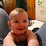 baby, smile, child, indoor, wall, door, graffiti, sign, jeans, person, bed, toy, furniture, skin, room, happy, face, arm, expression, casual