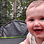 baby, smiling, face, outdoor, child, crawling, trampoline, trees, grass, daylight, happy, cute, infant, closeup, person, nature, play, summer, skin, tank_top