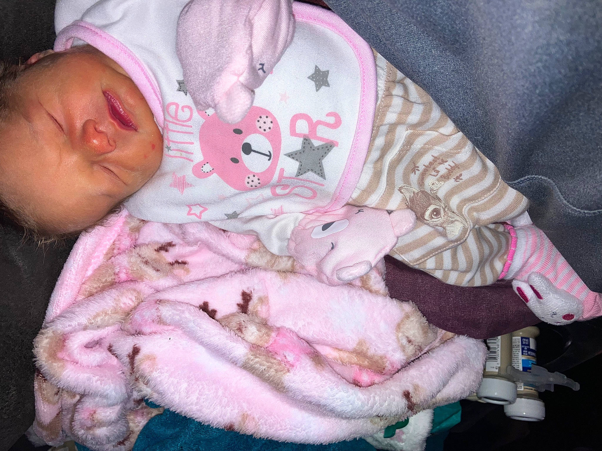 Sindaya is registered to the contest to win money with this photo: baby, baby_products, baby_toddler_clothing, cheek, child, comfort, flesh, fur, lap, linens, magenta, nail, pattern, person, pink, room, sitting, sleeve, textile, toddler