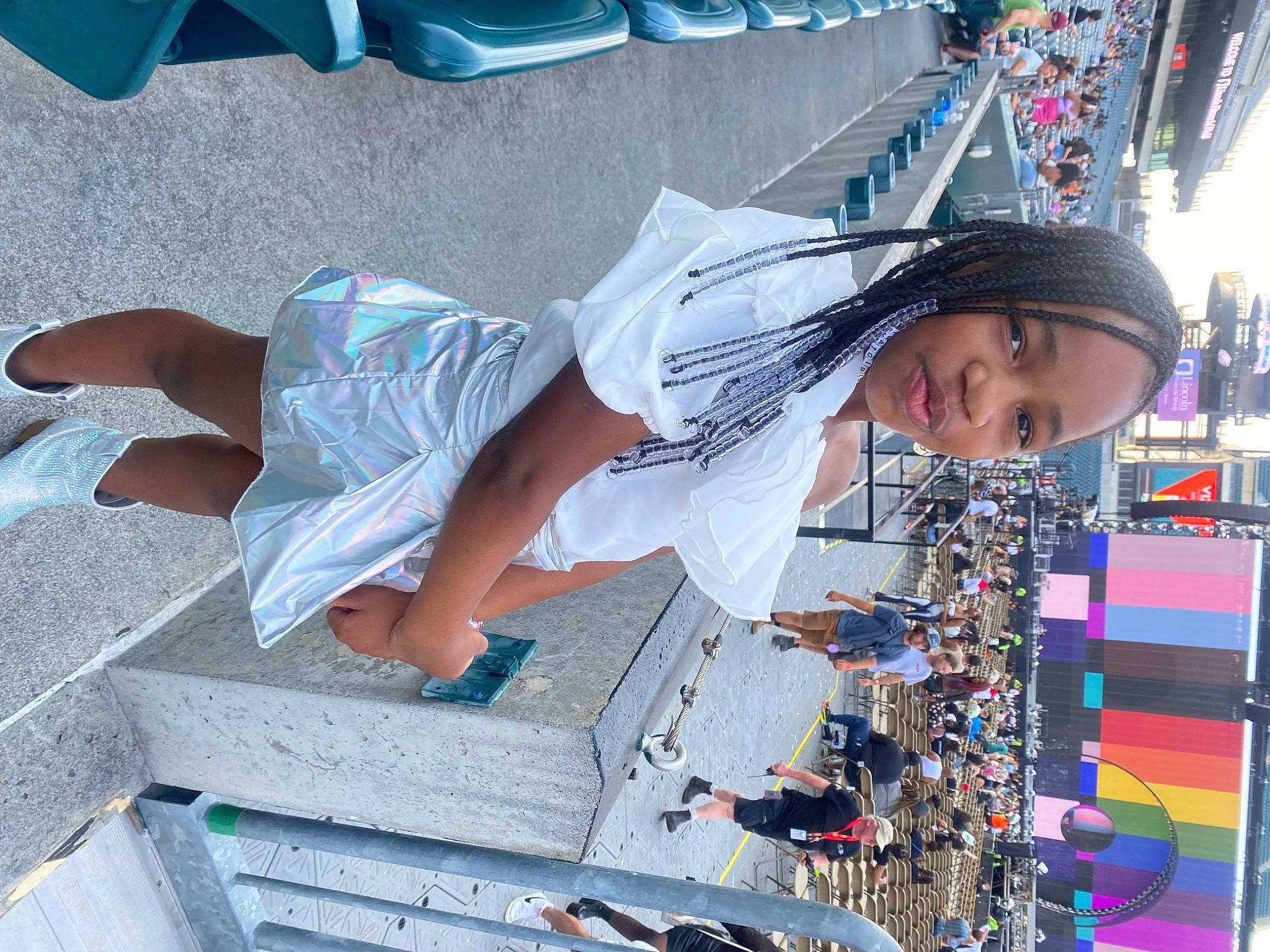 Kennedy is registered to the contest to win money with this photo: blue, blurred, child, city, event, eyewear, flip_flops, foot, fun, hat, human_leg, leisure, person, recreation, sandal, shorts, t_shirt, thigh, toddler, travel