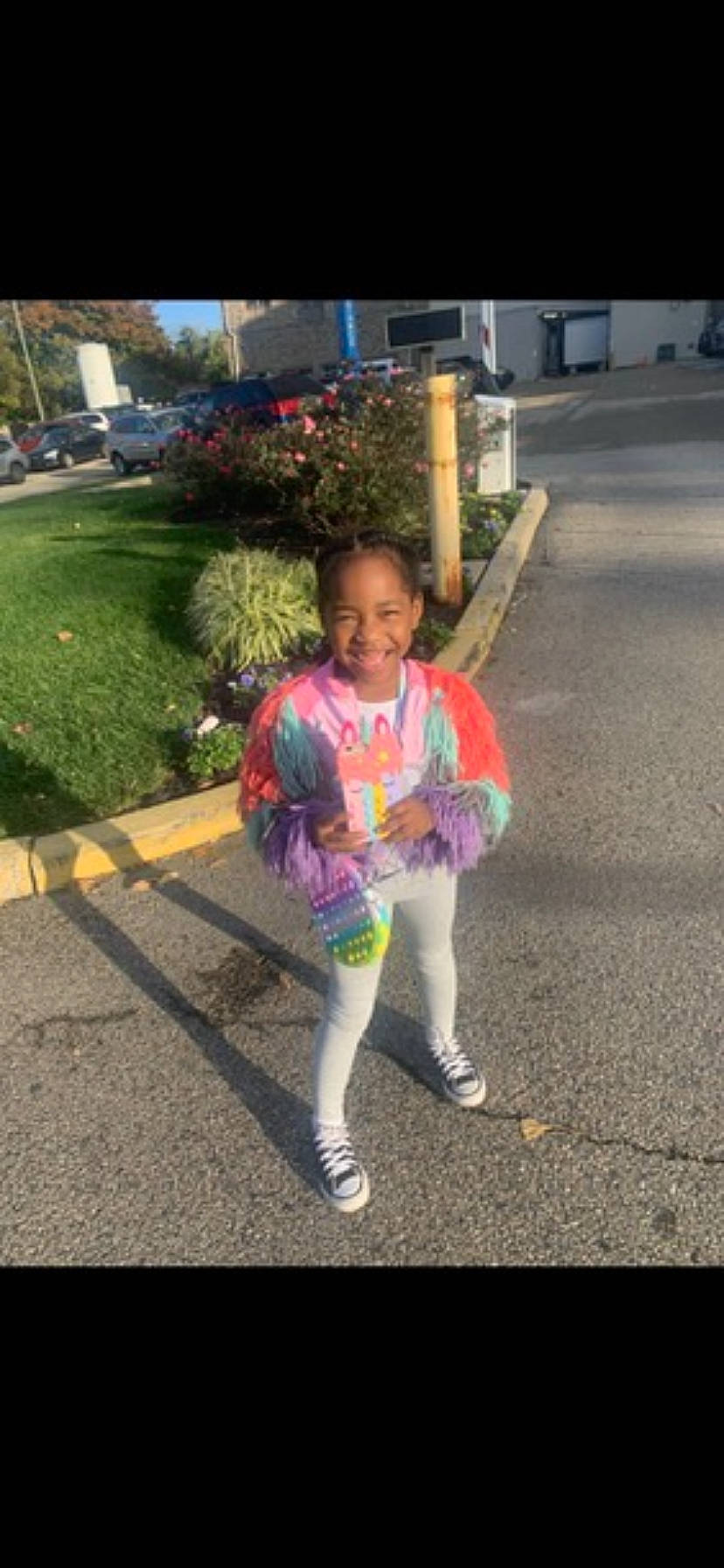 Kennedy is registered to the contest to win money with this photo: asphalt, fashion_accessory, fun, fur, grass, happy, joy, leaf, leisure, magenta, pedestrian, person, pink, plant, recreation, road, road_surface, sidewalk, smile, t_shirt