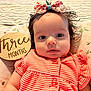 Nicole joined the competition — help win amazing prizes! baby, infant, bow, pink, striped_clothing, coral, pillow, floral, wooden_sign, three_months, face, portrait, lying_down, cute, child, newborn, expression, soft_lighting, indoors, person