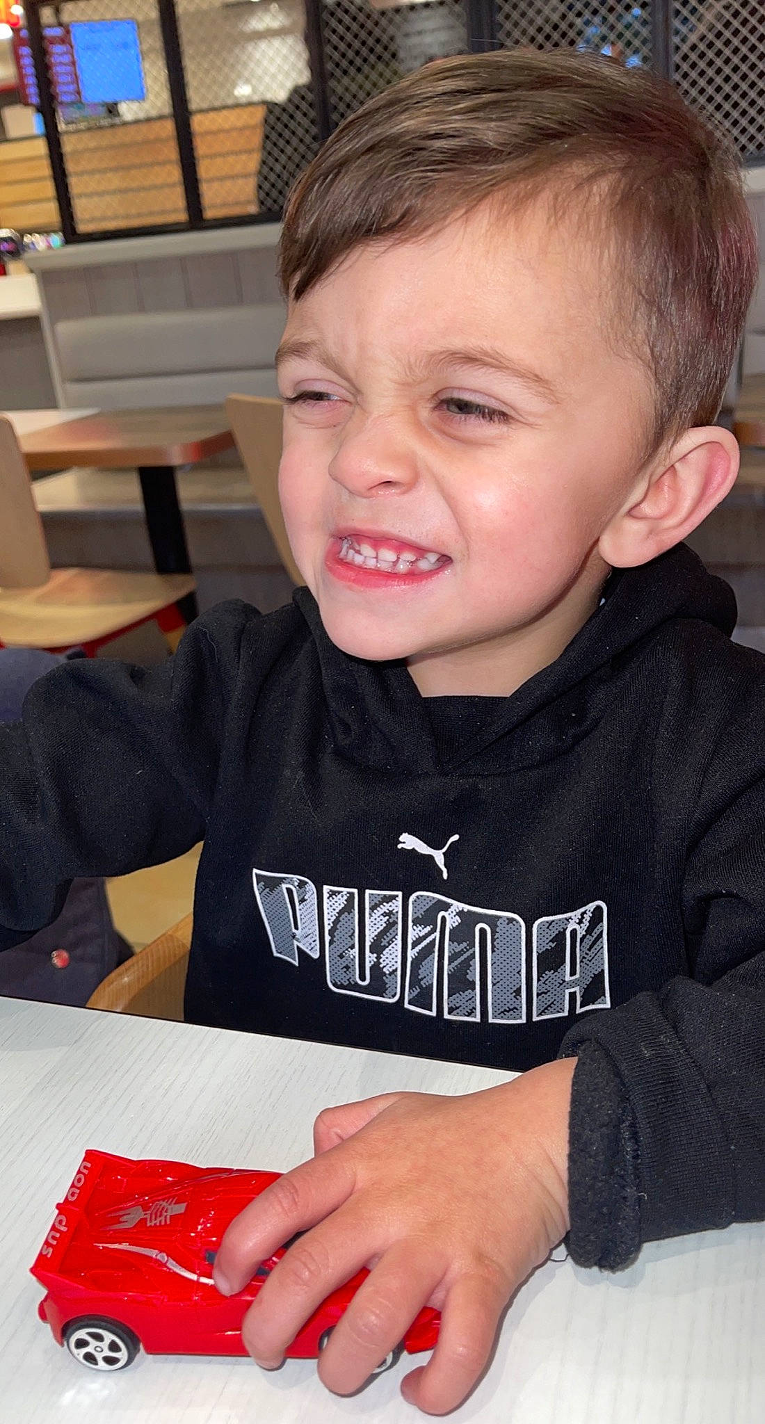 Khyro is registered to the contest to win money with this photo: baby_toddler_clothing, black, carmine, chair, cheek, child, event, eyelash, finger, fun, happy, mammal, office_supplies, organ, person, sitting, sleeve, smile, t_shirt, table