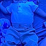 baby, infant, blue_light, polo_shirt, pants, blanket, pacifier, tattoo, sock, lying_down, curious_expression, child, indoor, clothing, person, portrait, young_child, casual, cozy, soft_fabric