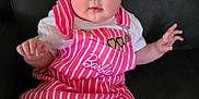 Amelia is registered to the contest to win money with this photo: baby, child, girl, headband, flower, pink_dress, striped_clothing, barbie, heart_patch, sitting, couch, indoor, cute, portrait, blue_eyes, white_shirt, infant, hand, face, looking