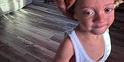 Roman joined the competition — help win amazing prizes! toddler, child, indoors, floor, hat, knit_hat, orange, barefoot, white_shirt, tank_top, living_room, couch, wooden_floor, furniture, small_chair, table, person, home, blur, casual