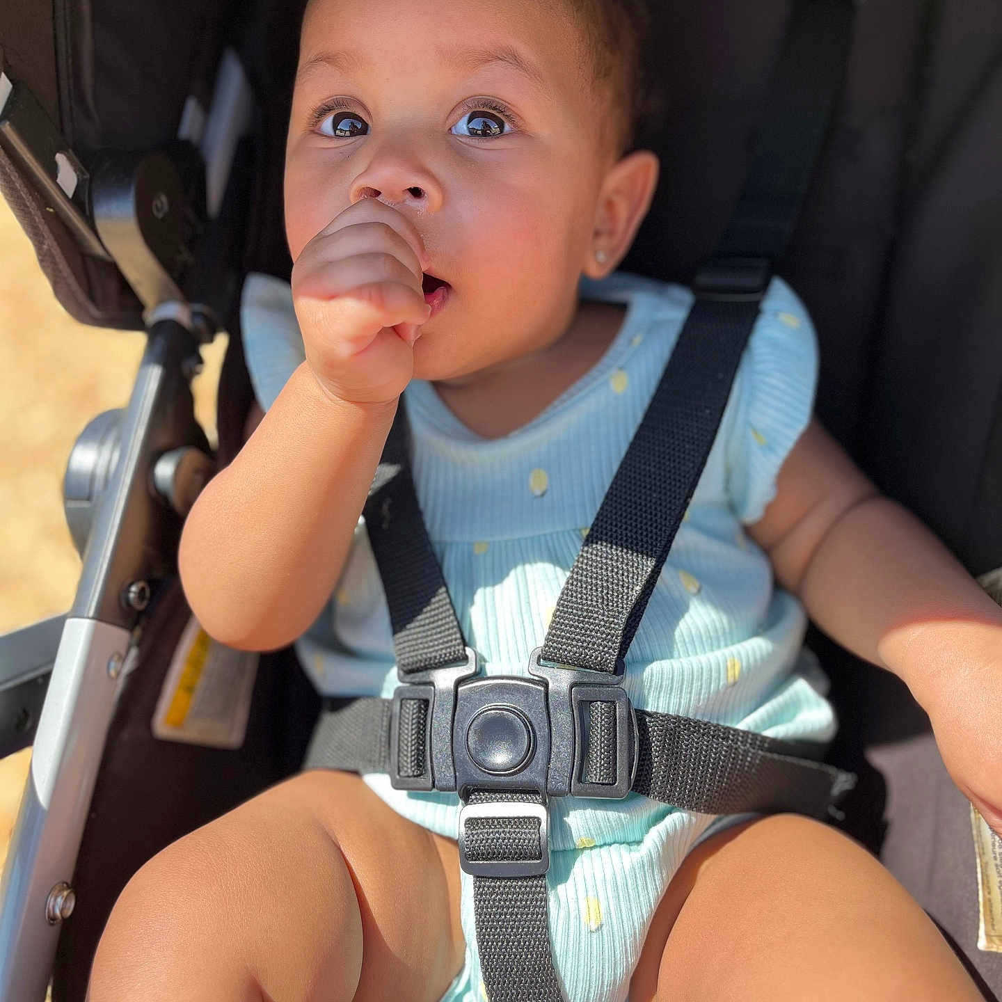 Audrey is registered to the contest to win money with this photo: accessories, baby, bodypart, clothing, cream, dessert, face, finger, food, hand, head, icecream, person, photography, portrait, shorts, sitting, strap, stroller, t_shirt