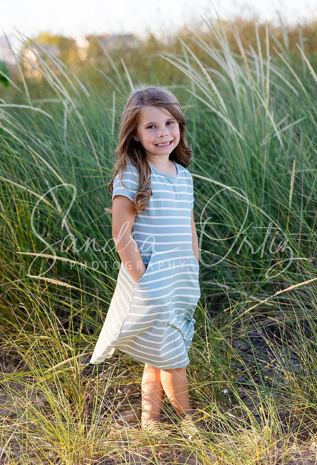 Skylynn is registered to the contest to win money with this photo: dress, ecoregion, flash_photography, grass, grass_family, grassland, hairstyle, happy, joy, landscape, long_hair, meadow, nature, people_in_nature, person, plain, plant, prairie, smile, summer
