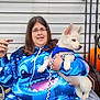 woman, puppy, dog, blue_hoodie, glasses, sitting, porch, pumpkin, leash, smile, casual, outdoor, pet, holding, jeans, metal_railing, white_dog, fall, happy, portrait