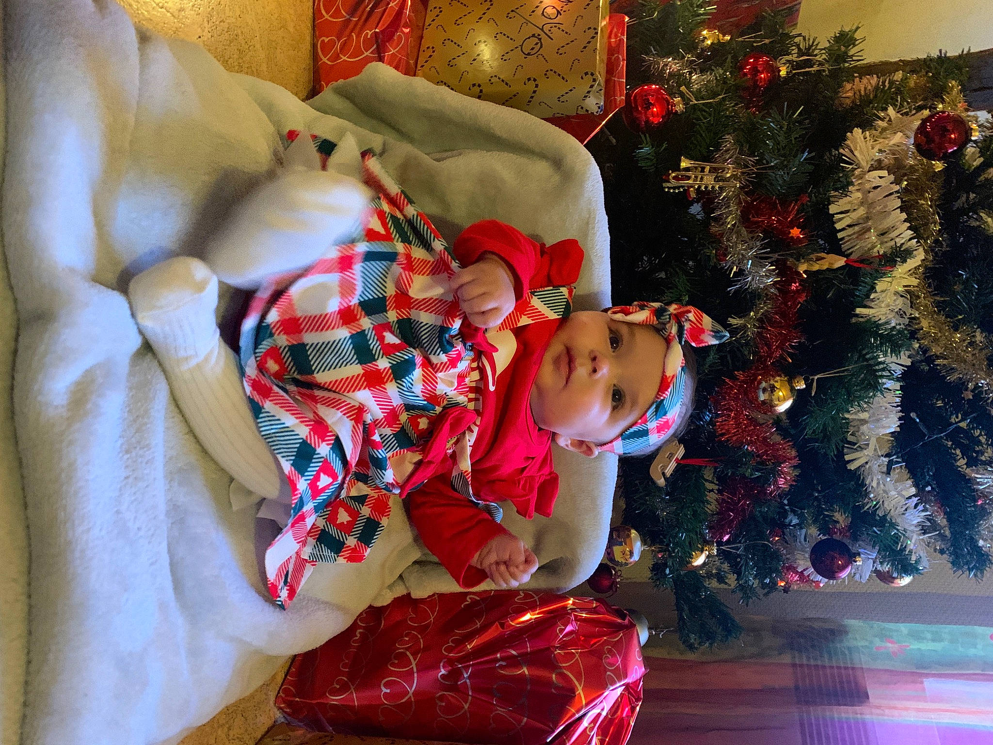 Luna a rejoint le concours — aidez-le/la à gagner de superbes lots ! baby, baby_toddler_clothing, christmas, christmas_decoration, christmas_ornament, christmas_tree, event, happy, head, headwear, holiday, holiday_ornament, human_body, lap, leg, ornament, person, plant, red, room