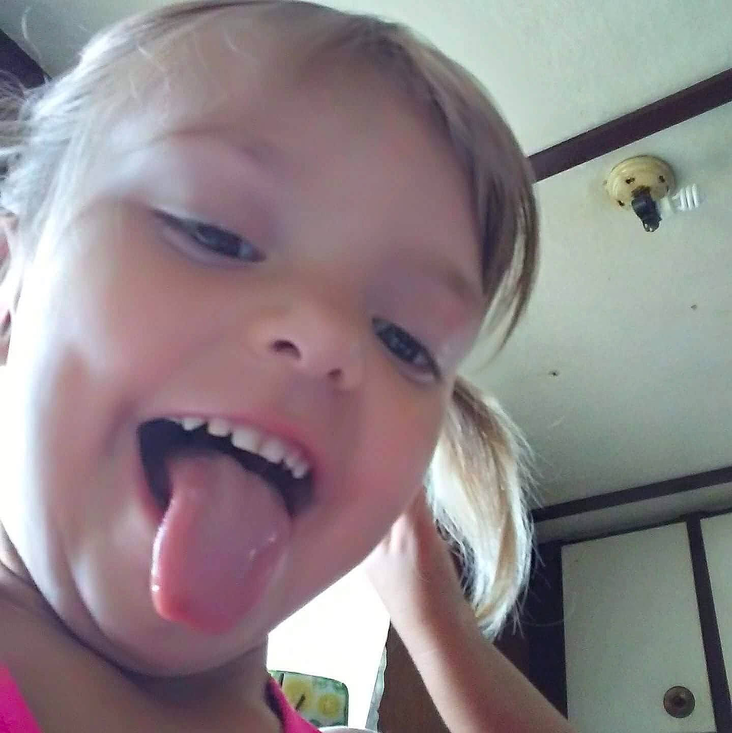 Harmony Cruz is registered to the contest to win money with this photo: cheek, chin, ear, eyebrow, eyelash, finger, gesture, happy, human_body, iris, jaw, lip, mouth, neck, nose, person, skin, smile, toddler, tongue