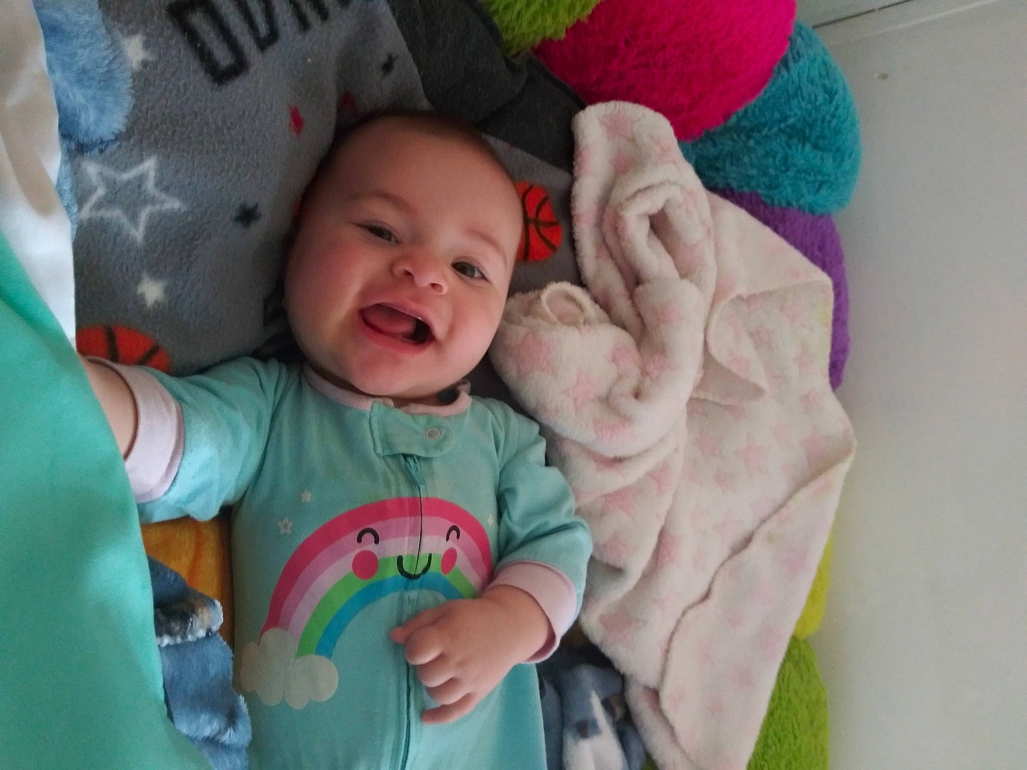 Ariel is registered to the contest to win money with this photo: arm, baby, baby_toddler_clothing, cheek, comfort, eye, facial_expression, finger, gesture, green, hand, happy, mouth, nose, person, pink, product, skin, sleeve, smile
