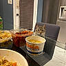 Beamer is registered to the contest to win money with this photo: cat, chair, container, curious, dining, door, food, glass_table, indoor, kitchen, meal, mexican_food, pet, plastic_container, queso, refrigerator, salsa, snack, table, window_blinds
