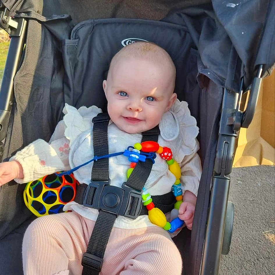 Eliana Michele joined the competition — help win amazing prizes! accessories, architecture, baby, building, city, clothing, face, furniture, head, outdoors, pants, person, photography, portrait, road, shelter, strap, street, stroller, sunglasses