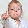Eden participe au concours pour gagner de l'argent avec cette photo : toddler, child, pointing, white_shirt, portrait, face, light_hair, serious_expression, indoor, closeup, cute, young_child, person, innocent, baby, skin, eyes, buttoned_shirt, hand, looking