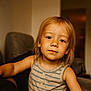 Eden a rejoint le concours — aidez-le/la à gagner de superbes lots ! child, toddler, blonde_hair, striped_shirt, indoor, portrait, person, cute, smiling, young, face, skin, eyes, hair, sleeveless, warm_lighting, cozy, furniture, background_blur, casual