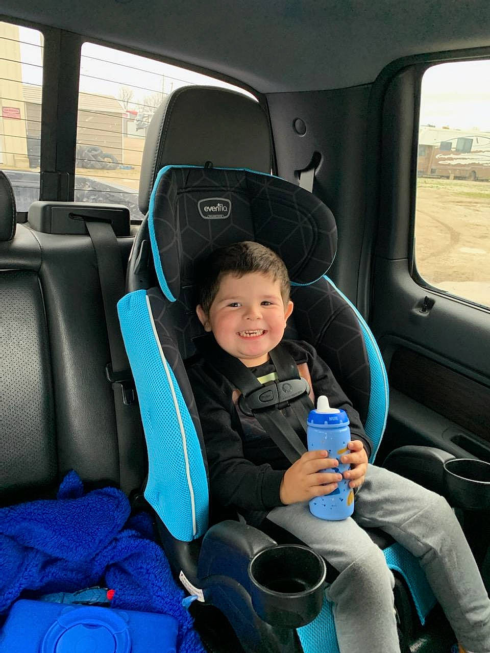 Landon joined the competition — help win amazing prizes! auto_part, automotive_design, blue, bottle, car, car_seat, car_seat_cover, comfort, head_restraint, joy, motor_vehicle, person, plant, seat_belt, smile, steering_part, steering_wheel, toddler, vehicle, vehicle_door