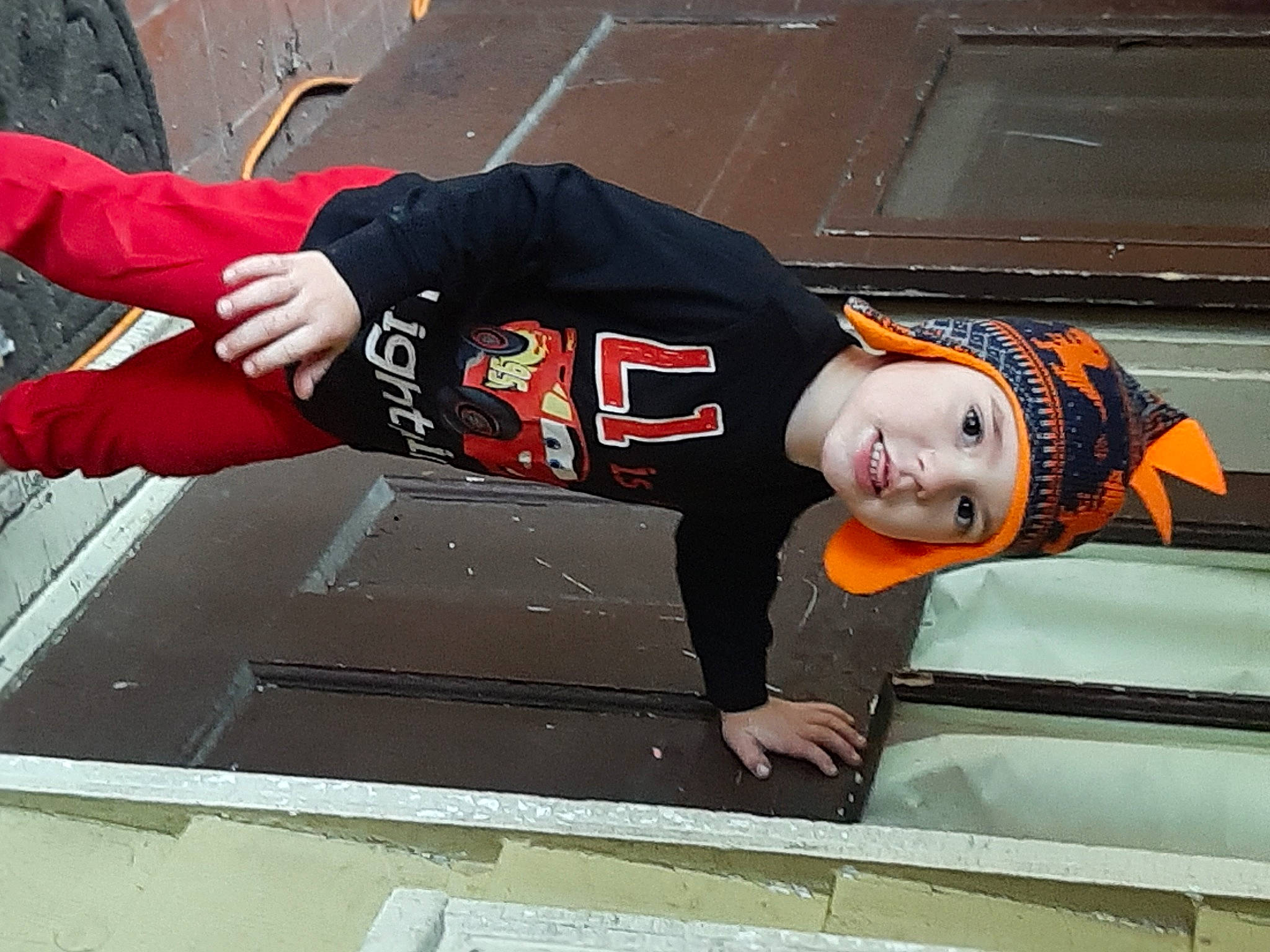 Liam joined the competition — help win amazing prizes! asphalt, carmine, composite_material, concrete, cool, flooring, glove, hat, headwear, person, personal_protective_equipment, recreation, road_surface, sidewalk, sleeve, smile, sportswear, street_fashion, t_shirt, toddler