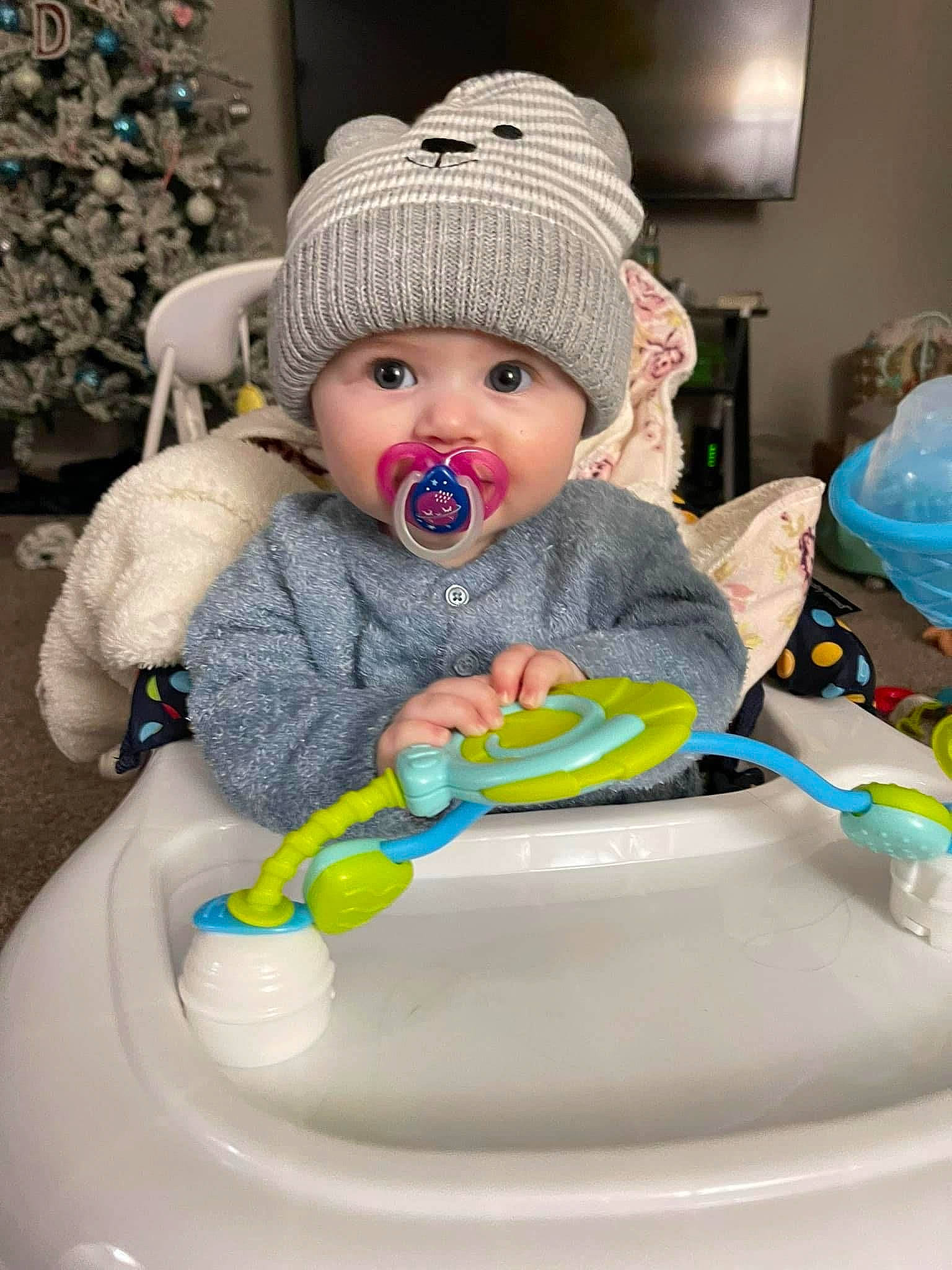 Avaleigh is registered to the contest to win money with this photo: baby, baby_products, baby_toddler_clothing, bib, blue, cap, cheek, child, dishware, drinkware, fashion_accessory, fun, happy, headgear, headwear, human_body, knit_cap, person, personal_protective_equipment, sitting