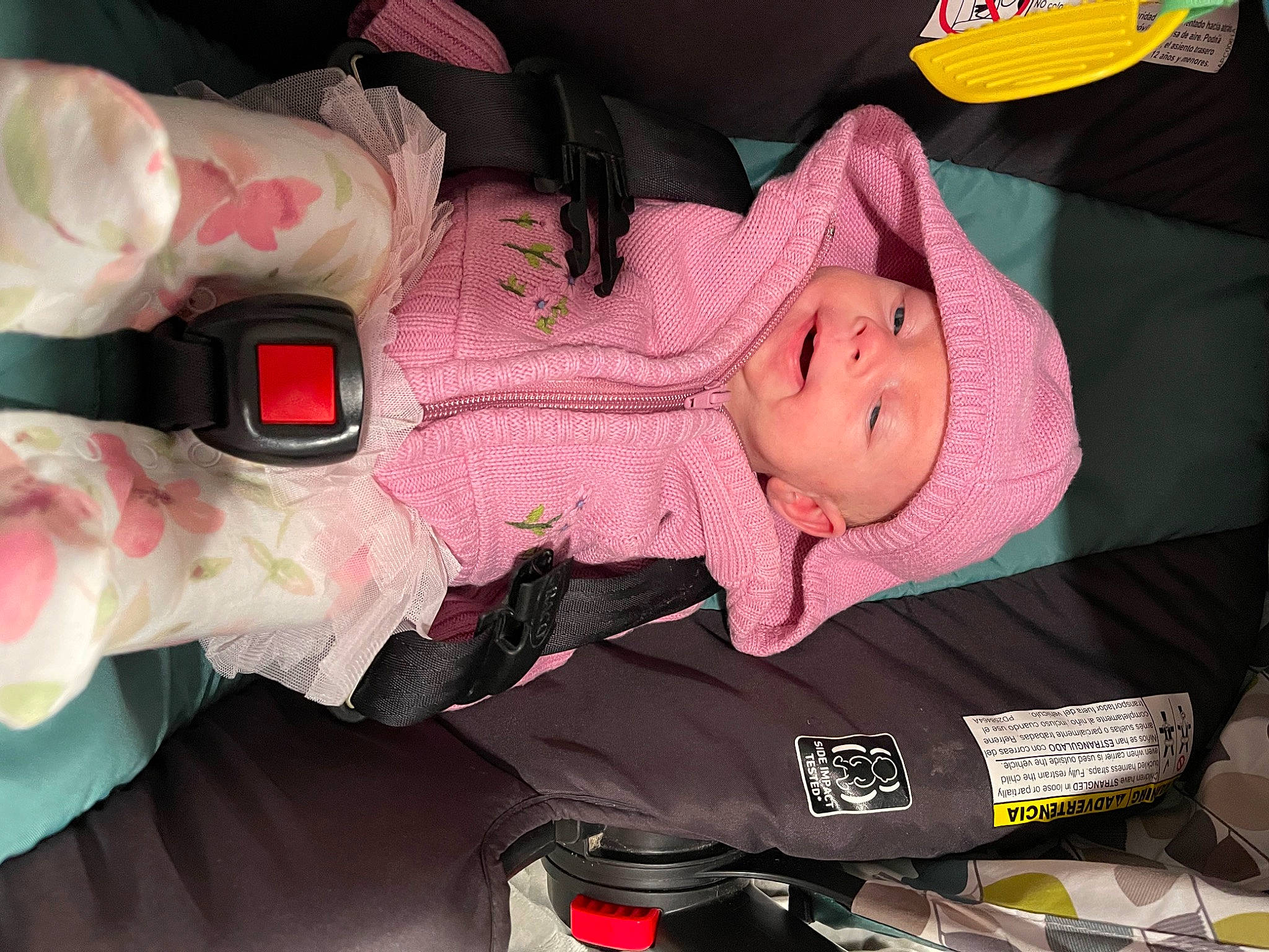 Celeste is registered to the contest to win money with this photo: auto_part, baby, baby_carriage, baby_products, baby_safety, baby_toddler_clothing, car_seat, carmine, cheek, child, comfort, fun, headwear, human_body, magenta, person, pink, product, room, skin