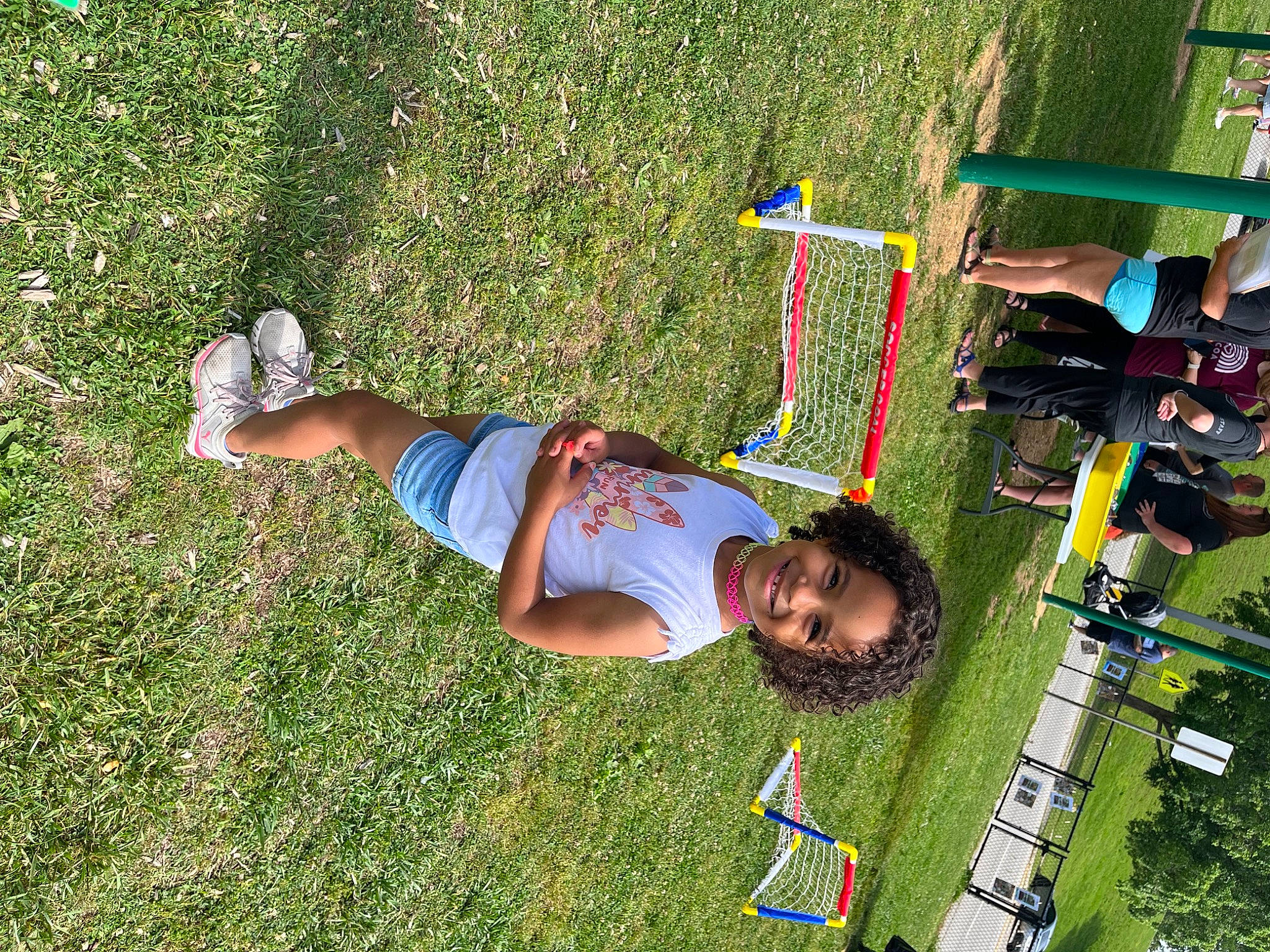 Realynn is registered to the contest to win money with this photo: bicycle_handlebar, child, city, fun, grass, grassland, green, joy, landscape, lawn, leisure, natural_environment, nature, outdoor_play_equipment, people_in_nature, person, plant, play, recreation, shorts