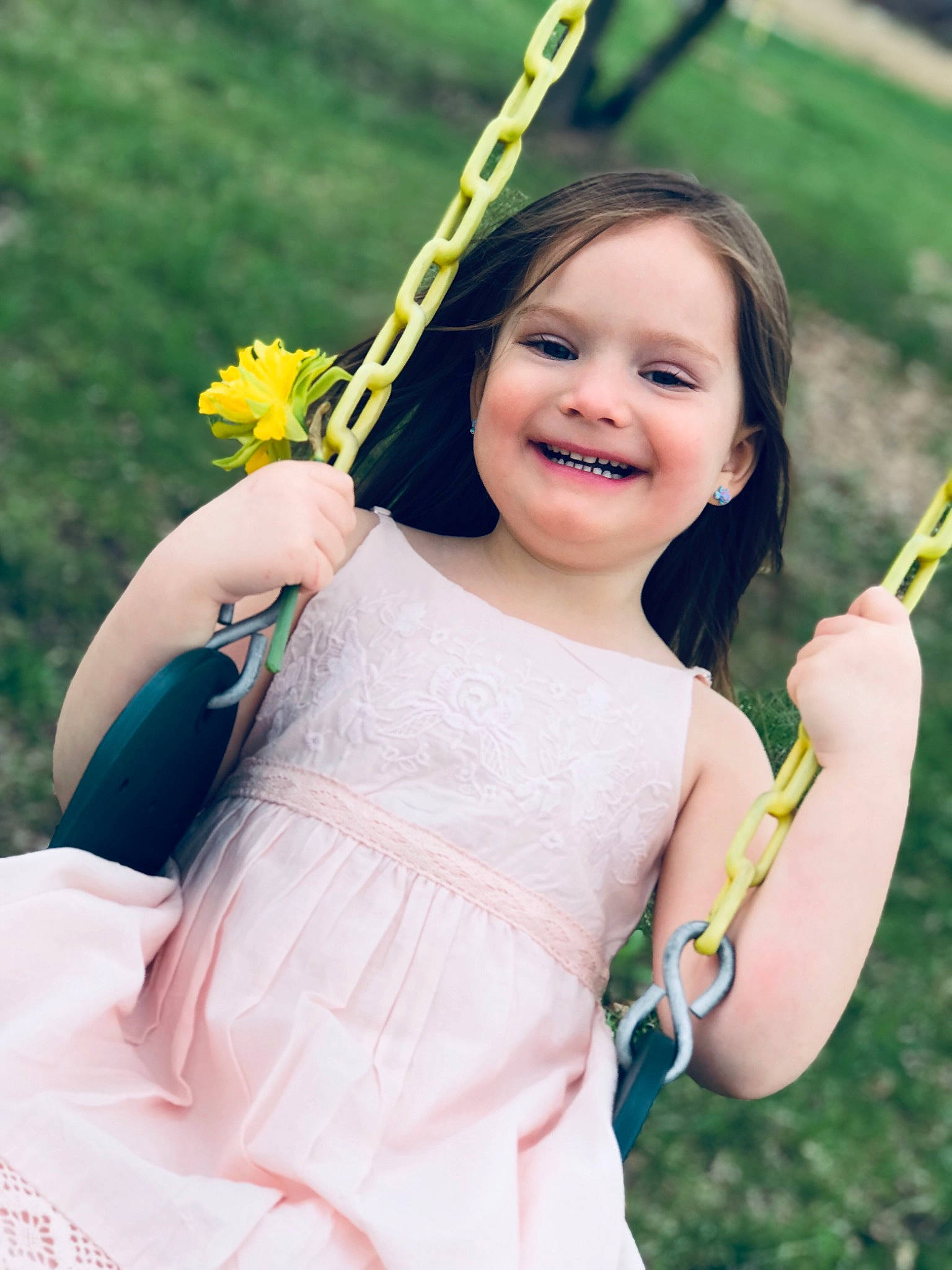 Myra is registered to the contest to win money with this photo: beauty, child, child_model, dress, facial_expression, flower, grass, happy, joy, person, photography, plant, portrait, portrait_photography, skin, smile, swing, toddler, yellow