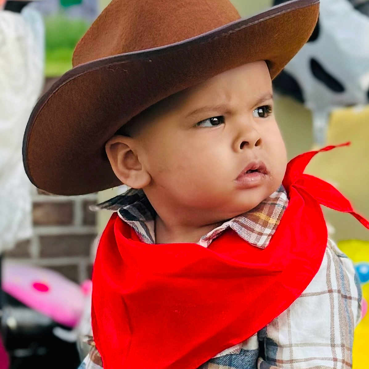 Kylian is registered to the contest to win money with this photo: baby, casual, child, clothing, costume, cowboy_hat, cute, face, fashion, hat, headwear, kid, outdoor, person, plaid_shirt, portrait, red_bandana, serious_expression, toddler, young_child