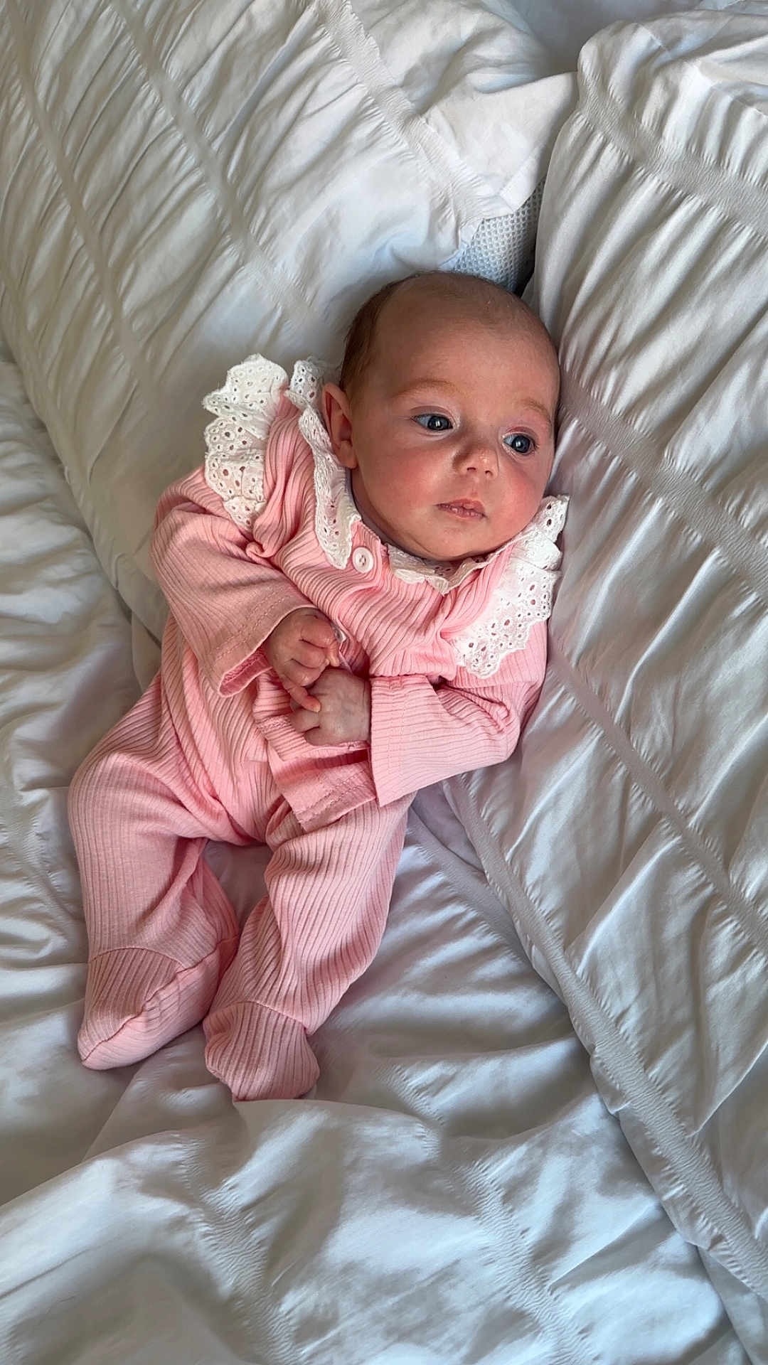 Malina joined the competition — help win amazing prizes! infant, baby, pink_clothing, white_bedspread, lace, cozy, portrait, child, sleepwear, soft_texture, cute, newborn, lying_down, bed, resting, small_hands, curious, indoors, peaceful, comfort