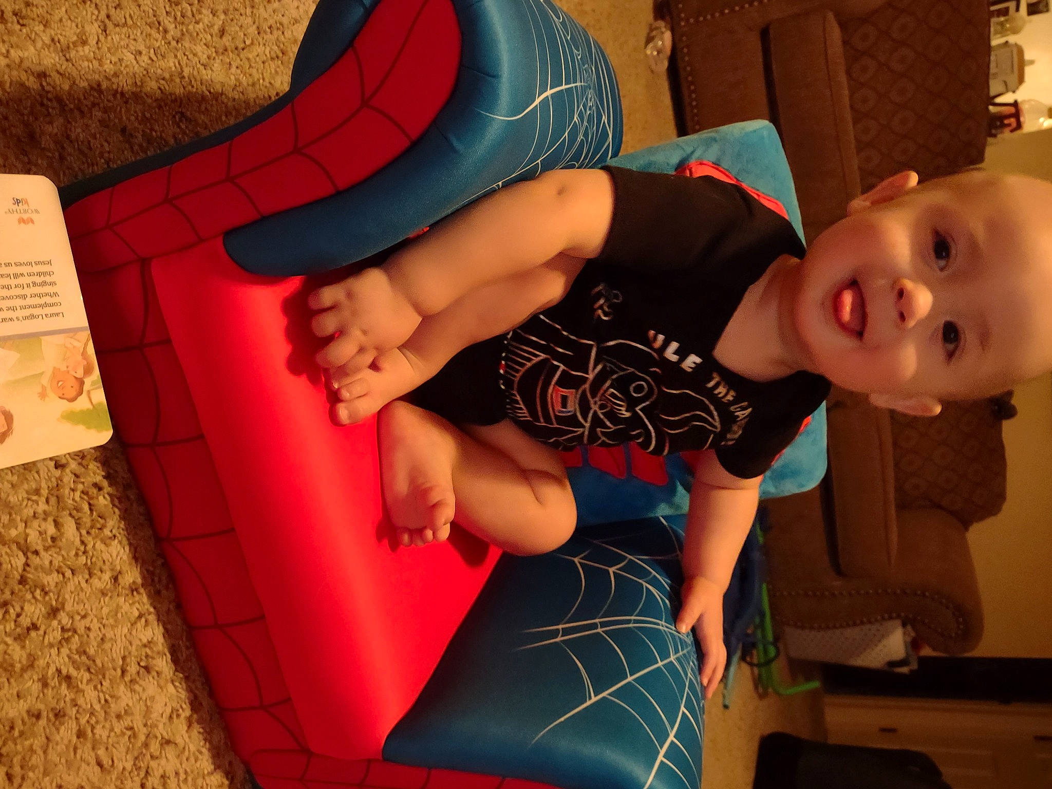 Hagen is registered to the contest to win money with this photo: arm, baby, baby_toddler_clothing, child, finger, flooring, fun, hand, human_body, human_leg, joint, knee, mouth, pattern, person, pink, sitting, smile, t_shirt, thigh