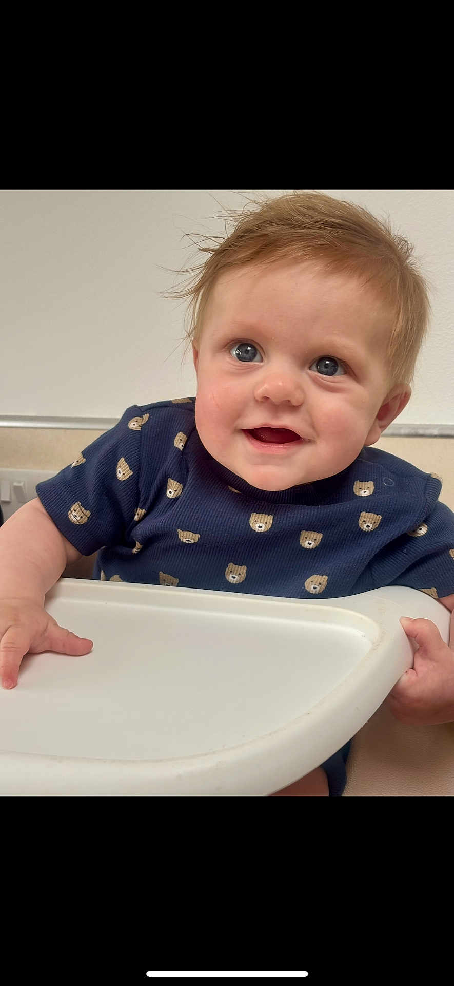 Reggie joined the competition — help win amazing prizes! baby, child, smiling, high_chair, blue_eyes, short_hair, toddler, clothing, bear_pattern, indoor, person, cute, happy, skin, face, hand, sitting, infant, young_child, portrait