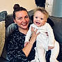 Reggie is registered to the contest to win money with this photo: baby, casual, child, clothing, couch, cozy, family, happy, holding, home, indoor, love, person, pillow, portrait, relaxing, seated, smiling, toddler, woman