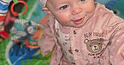 Lilith is registered to the contest to win money with this photo: baby, child, infant, pink_outfit, headband, bow, play_mat, toy, smiling, sitting, cute, indoor, carpet, clothing, face, person, happy, portrait, baby_girl, soft_texture