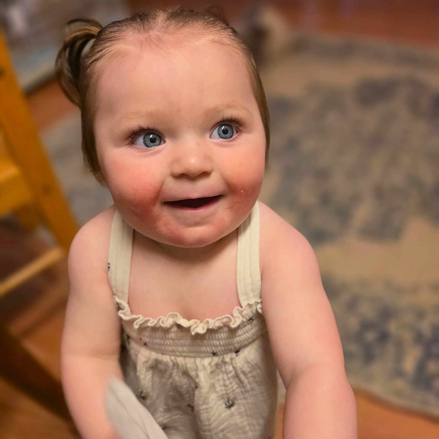 Rhaena is registered to the contest to win money with this photo: toddler, child, baby, blue_eyes, smiling, indoor, curly_hair, cloth, playful, cute, skin, dress, person, portrait, happy, standing, wooden_floor, carpet, home, young