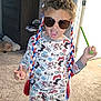 Andre is registered to the contest to win money with this photo: child, pajamas, sunglasses, braided_hair, toy, living_room, carpet, cabinet, door, playful, pose, fun, indoors, person, curly_hair, colorful, expression, footwear, furniture, home