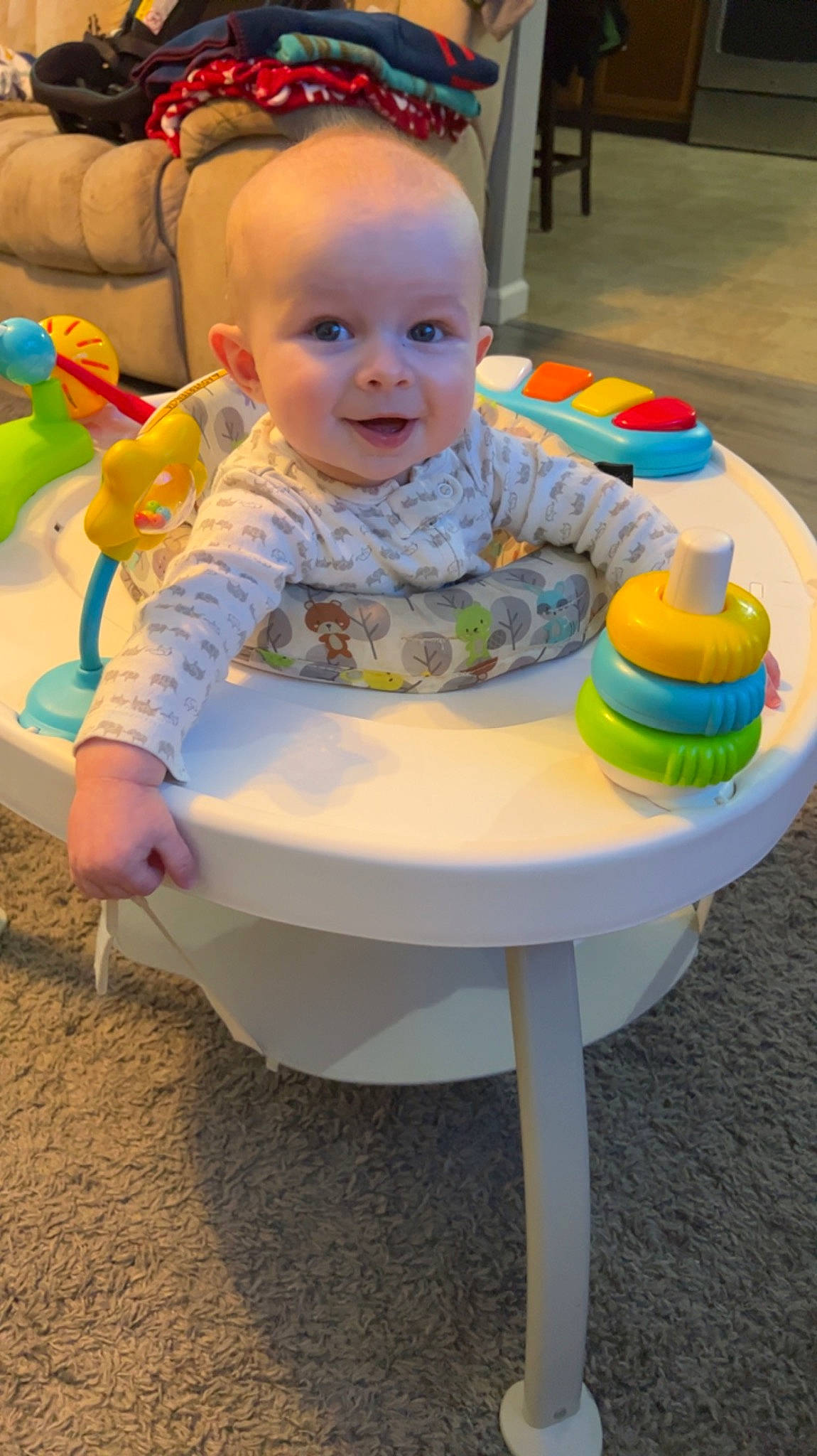 Easton is registered to the contest to win money with this photo: baby, baby_playing_with_toys, baby_products, baby_toddler_clothing, baby_toys, chair, child, event, face, fun, green, happy, leisure, person, recreation, sitting, smile, table, toddler, toy