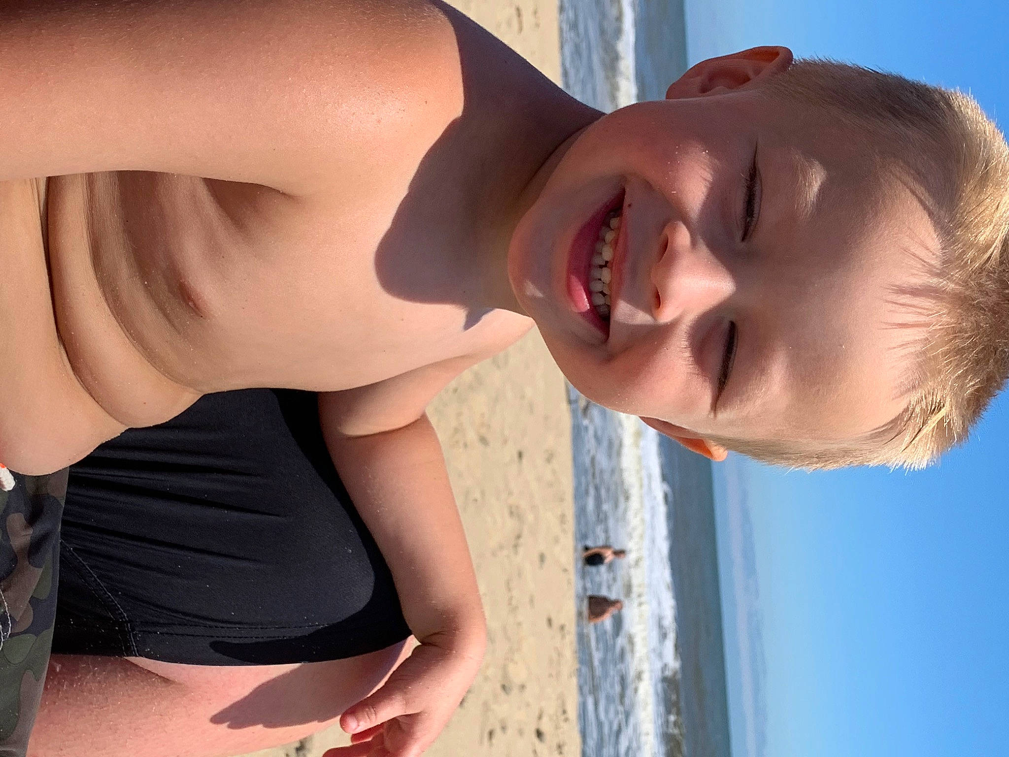 Jaece is registered to the contest to win money with this photo: beach, chin, clothing, eye, facial_expression, hairstyle, human, human_body, joy, light, mouth, neck, organ, people_on_beach, person, photograph, skin, sky, smile, water