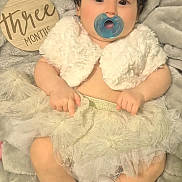 Debora joined the competition — help win amazing prizes! baby, blanket, booties, child, close_up, cute, dress, flower, frilly_skirt, headband, indoors, infant, lying_down, milestone_sign, pacifier, plush_fabric, portrait, sitting, three_months, white_outfit