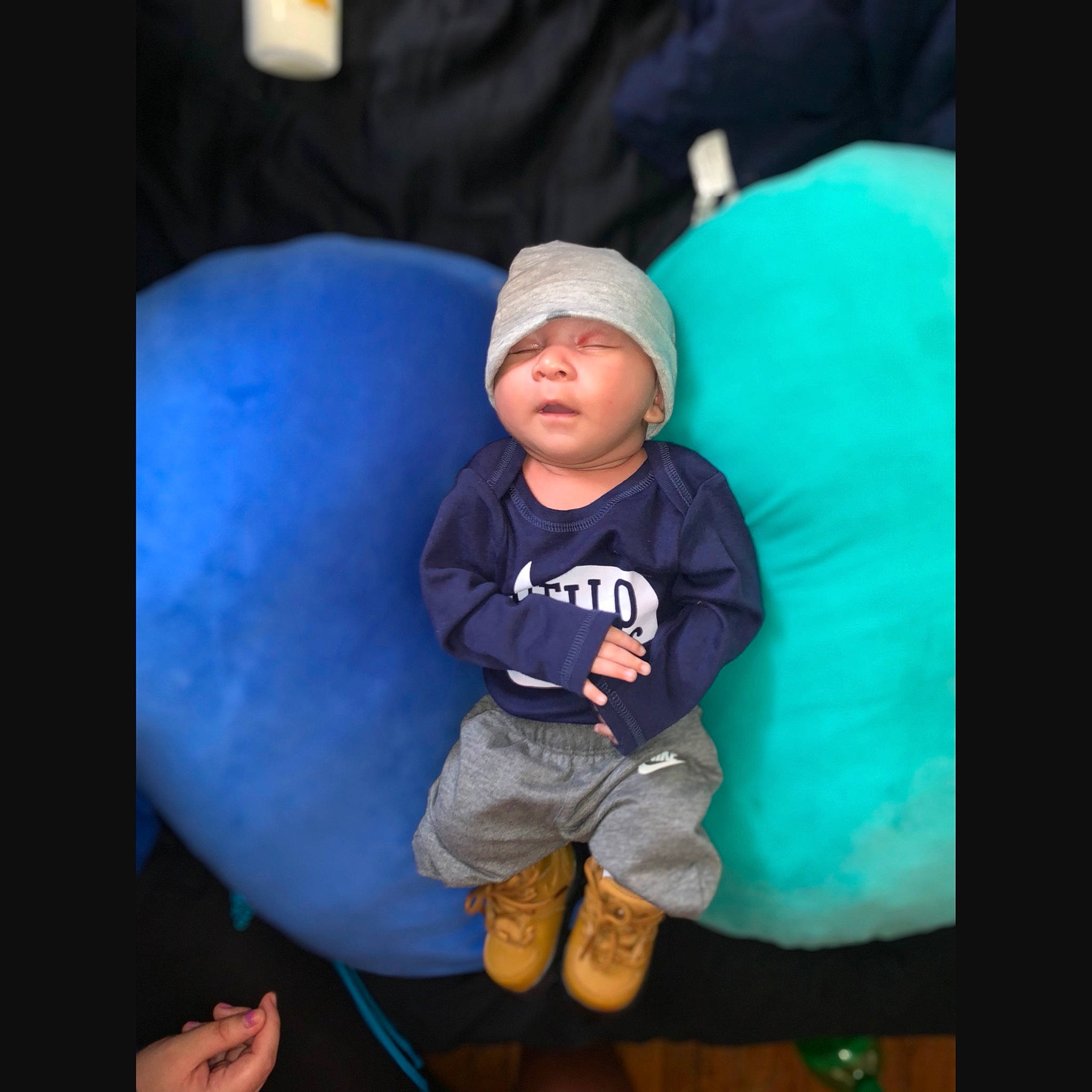 Diallo is registered to the contest to win money with this photo: baby, baby_toddler_clothing, baseball_cap, cap, child, comfort, cool, darkness, electric_blue, flash_photography, fun, happy, headwear, magenta, person, shorts, sitting, sleeve, space, t_shirt