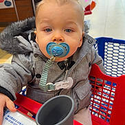 Noah a rejoint le concours — aidez-le/la à gagner de superbes lots ! child, baby, toddler, pacifier, pacifier_clip, shopping_cart, shopping_mall, coat, fur_hood, blue_eyes, face, close_up, sitting, hand, retail_store, portrait, bokeh, seat, toy_ride, winter_clothing