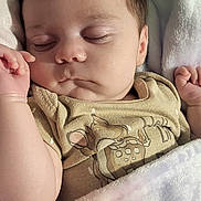 Paislee is registered to the contest to win money with this photo: baby, sleeping, blanket, onesie, infant, cute, peaceful, soft, pastel_colors, cartoon_print, face, hand, skin, hair, indoors, cozy, closeup, portrait, child, resting